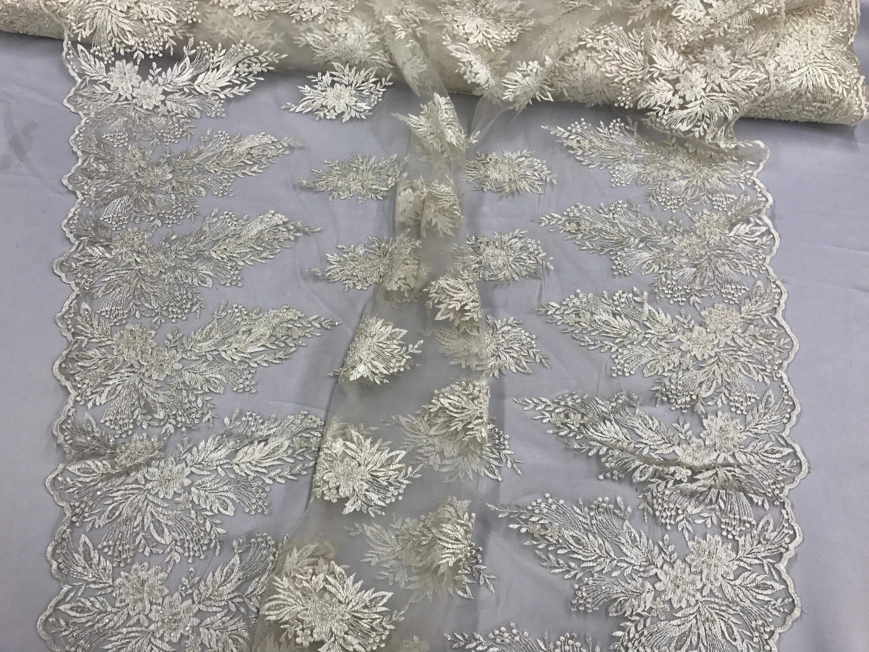 Ivory french design embroider with sequins and hand beaded on a mesh lace-wedding-bridal-prom-nightgown-decorations-sold by the yard.